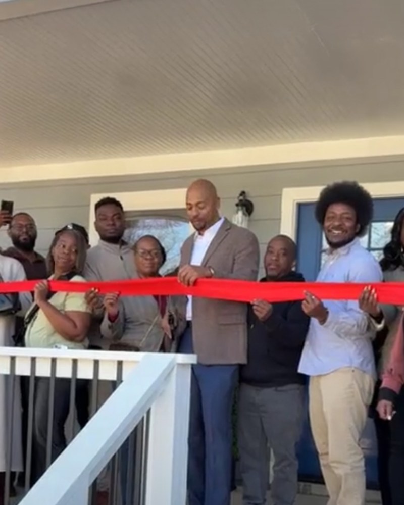 Charles Noonan at a ribbon-cutting ceremony for a renovated home